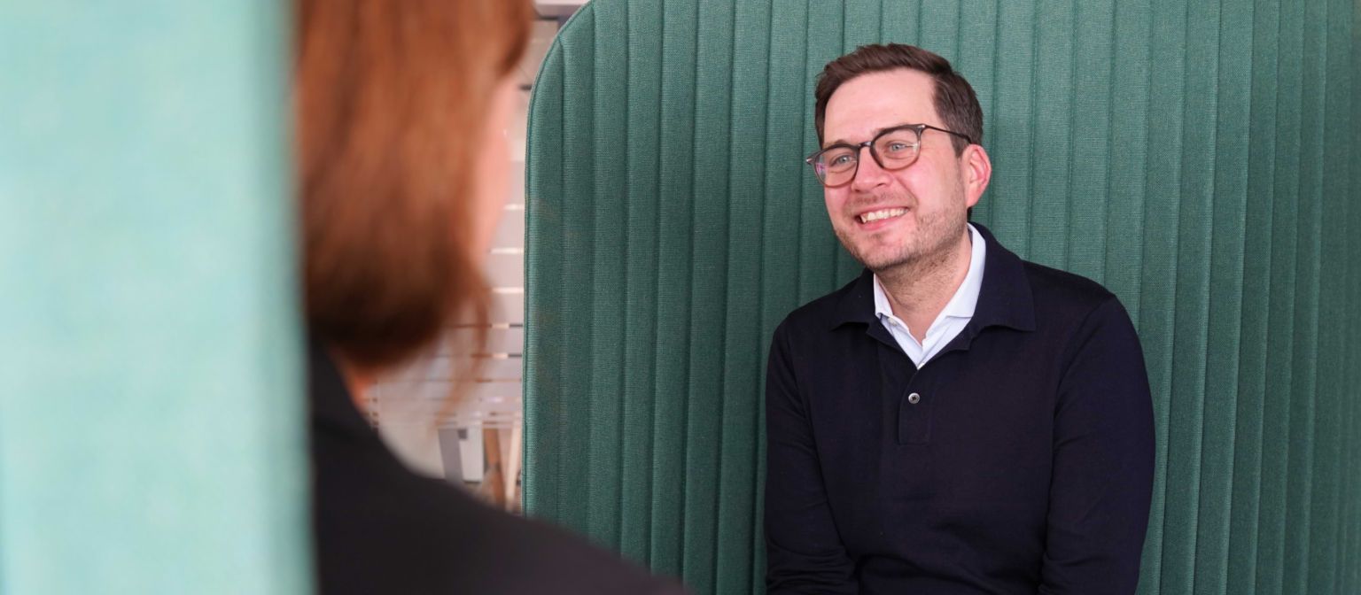 Man in een kantooromgeving tijdens een interview